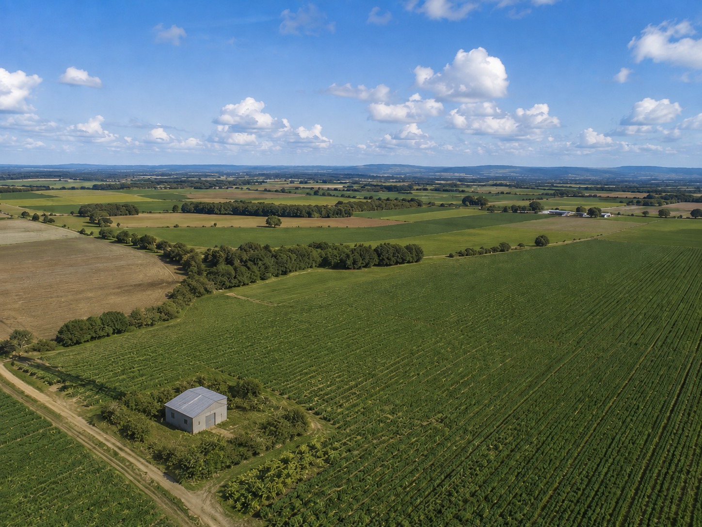Aerial view of remote farmland and outbuildings monitored by satellite-connected alarm hardware